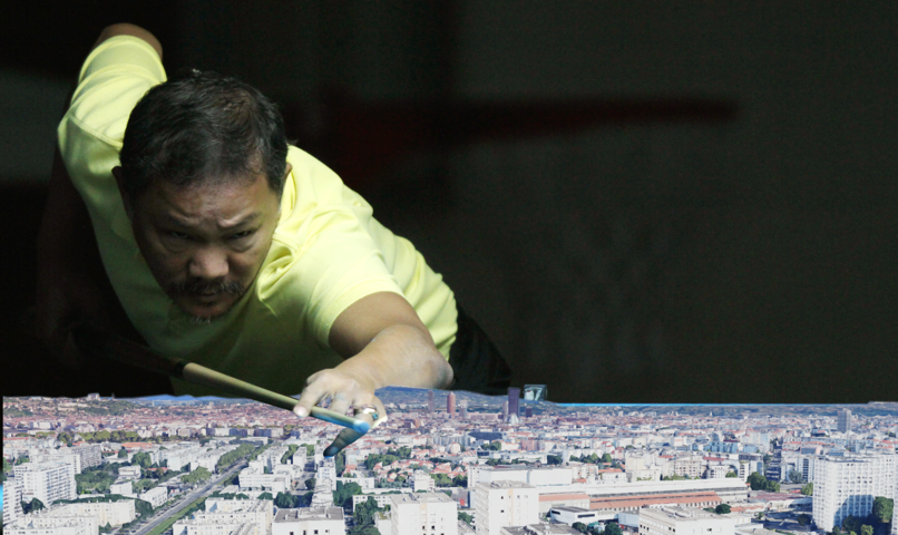 a guy leaning on a pool table to aim, but the pool table is actually google earth 3D view.