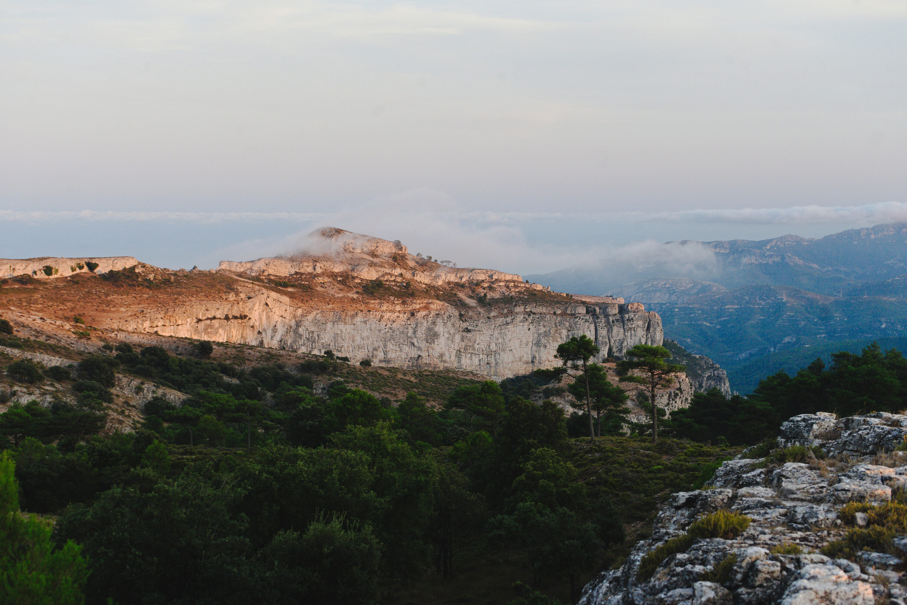 a photo taken from the top of the mountain, covered in rocks and the horizon stretching far away